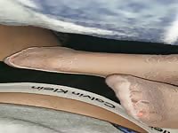 Mother teasing her son under pants with smelly nylon socks 